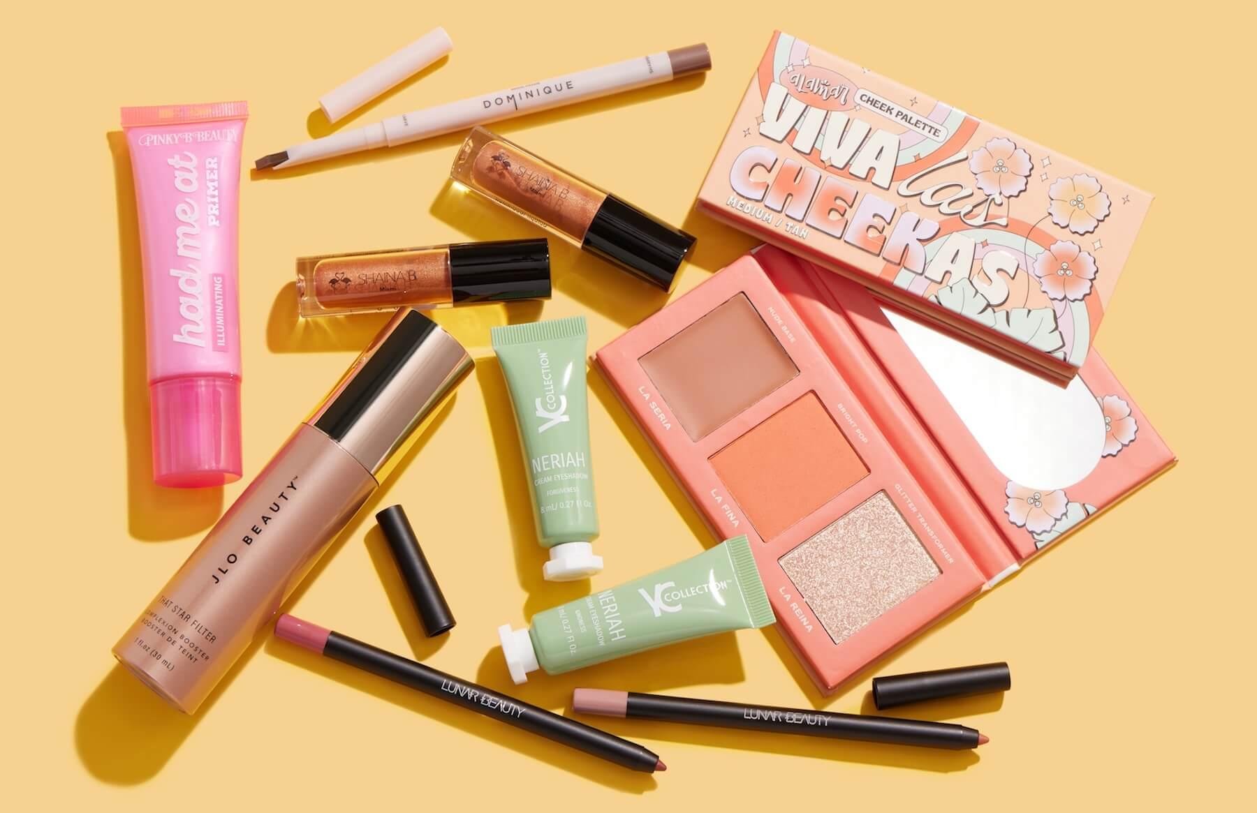 Flat-lay image of makeup and skincare products and tools from Latinx-led brands on yellow background